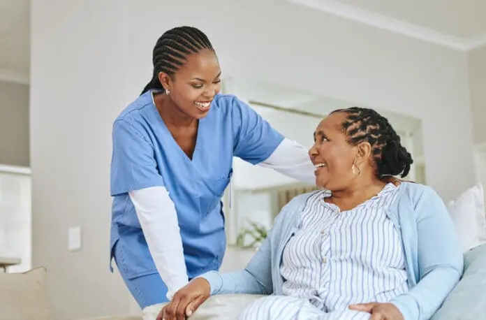 nurse-woman-senior-patient-talking-support-healthcare-happiness-retirement-home-black-person-happy-caregiver-together-trust-elderly-care-help-health-wellness-696x458